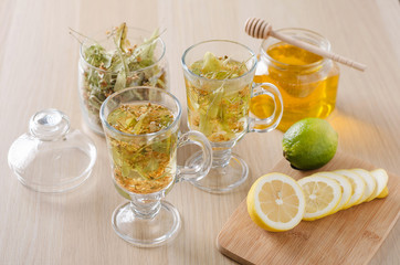 herbal tea with lemon and honey in a glass on a dark light background