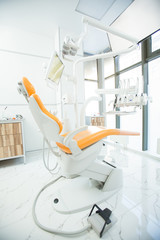 Interior of contemporary dental clinics with modern equipment and leather armchair for patients