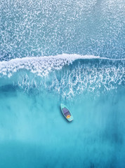 Wall Mural - wave and boat on the beach as a background. beautiful natural background at the summer time from air