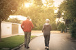 © Mladen - Senor couple jogging together trough city park. From back.