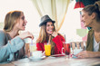 © Mediteraneo - Friends enjoying in conversation and drinking coffee.