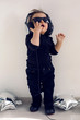 © saulich84 - one-year-old baby in black clothes listening to rock music in big headphones