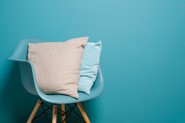 Two pillows in the interior in a minimalist style. Monocolor. Copy space