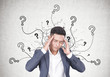 © ImageFlow - Stressed Asian businessman, question marks