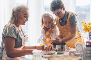 Wall Mural - Mom cooking with kids on the kitchen