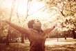 © Mladen - Satisfied African American girl with open arms dancing on meadow and looking in sky.