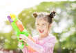 © Tom Wang - happy little girl playing water guns