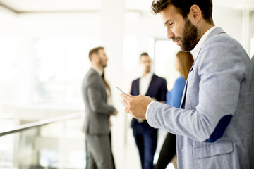 Poster - Handsome young businessman with mobile phone