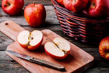 Wall Mural - red ripe apples in a basket on a wooden background