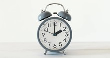 Traditional Alarm Clock On White Table , Time Running Concept , 4K Dci Resolution