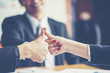 © chokniti - Business people shaking hands, finishing up a meeting