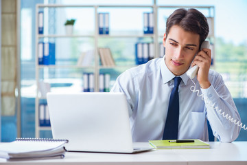 Businessman employee talking on the office phone