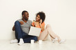 © Prostock-studio - Happy african-american couple shopping online