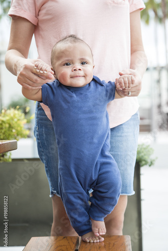 how to help a baby walk on his own