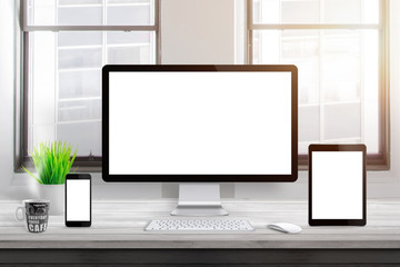 Leinwandbilder - Responsive devices mockup on office desk. Isolated, blank computer display, tablet and mobile phone.