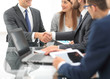 © ASDF - Business colleagues sitting at a table during a meeting with two