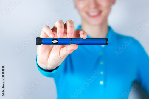 Fotografía Hand holding insulin pen on white background