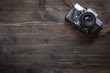 © IvicaNS - Old retro camera on wooden table background