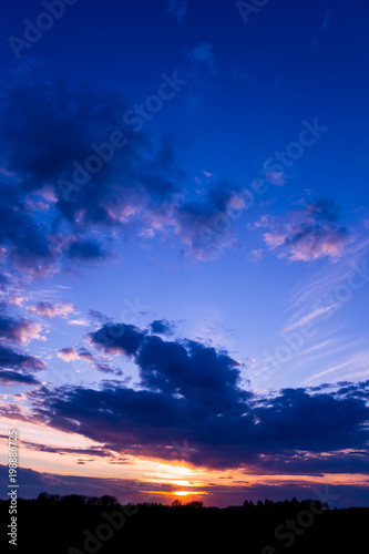 Vivid color clouds on sunset landscape. Blue sky with bright pink ...