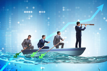 Team of businessmen in teamwork concept with boat