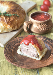 Wall Mural - Portion of beef Wellington with tomato sauce