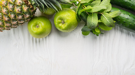 Wall Mural - Top viw of apple, pineapple and cucumber, close up