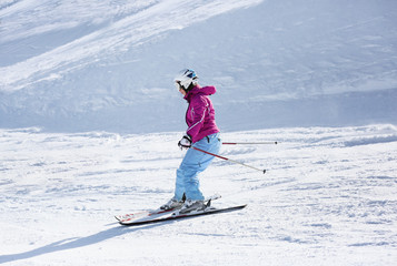 Sticker - Woman skiing on piste at snowy resort. Winter vacation