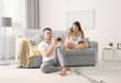 © Africa Studio - Emotional couple playing video game at home