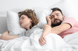 © Africa Studio - Husband and wife sleeping in bed at home