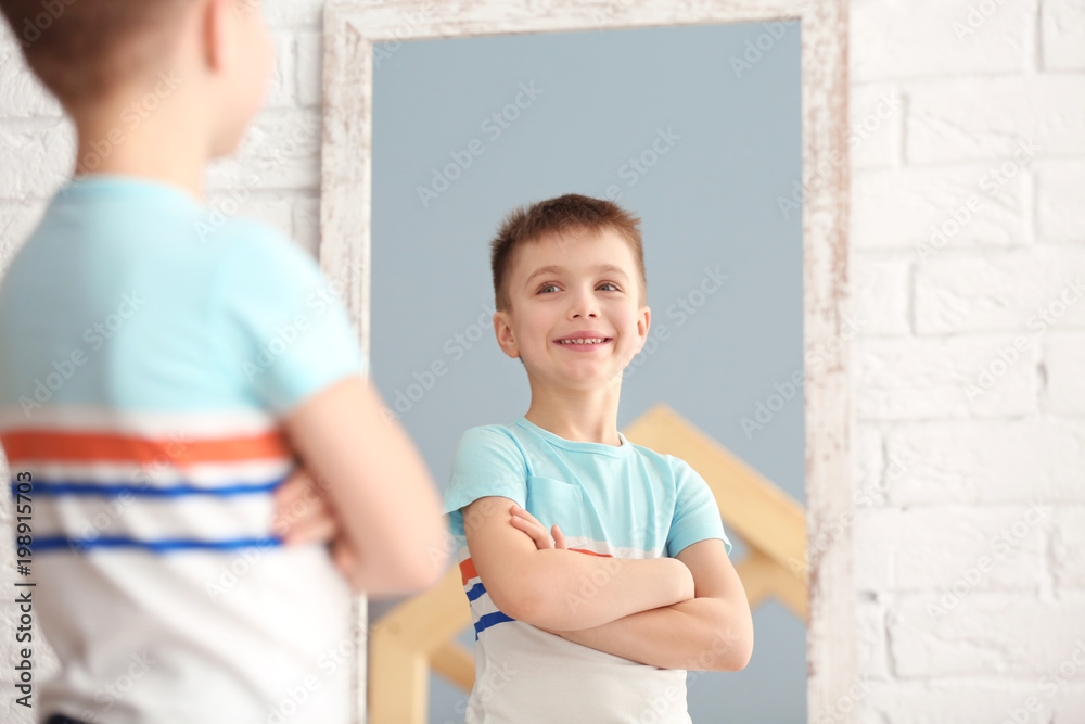 Cute little boy posing in front of mirror indoors - obrazy, fototapety, plakaty 