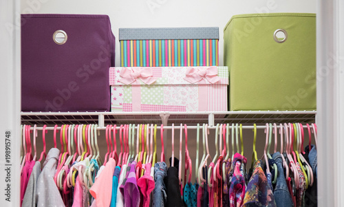 Fotomural A young girl's closet neatly organized with bins and boxes.