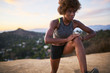 athletic african american woman doing stretches at runyon canyon