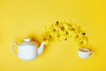 Yellow Chrysanthemums Pouring Into Cup From White Pot Isolated On Yellow