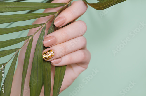 Beautiful female hand with beige nail design Tableau sur Toile