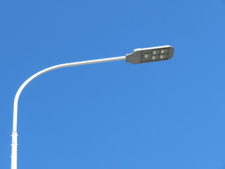 LED street lamp post isolated on blue sky background. Led lights saving electrical energy