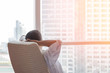 © Chinnapong - Life-work balance and city living life style concept of business man relaxing, take it easy in office room resting with thoughtful mind thinking of lifestyle quality looking forward to urban scene