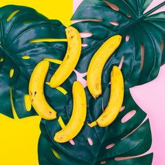 Wall Mural - a handful of bananas are lying on palm leaves. pastel minimal concept of food