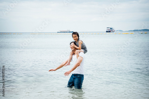 Poster Father and daughter having fun on beach