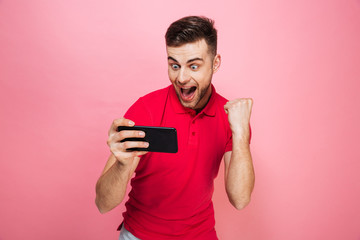 Wall Mural - Portrait of an excited young man playing games