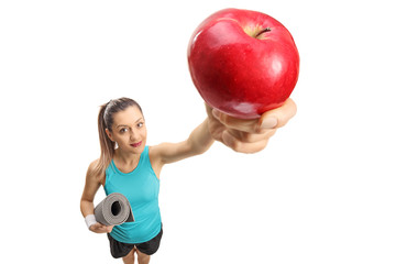 Wall Mural - Fitness woman with an exercise mat and an apple