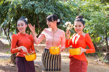 Wall Mural - Beautiful Thai girl in Thai costume playing water in Songkran day.