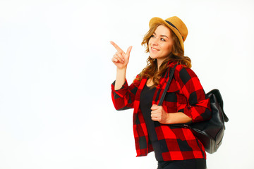 Wall Mural - Portrait of young beautiful blond smiley tourist girl holding black suitcase and showing above presenting your product