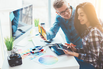 Cute creative designers working on new project in modern office