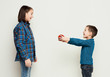 © Prostock-studio - Brother giving his sister gift, white studio