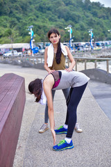 Sports concept. Beautiful girl is exercising on the beach with warm up. Beautiful girl is happy to exercise.