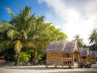 Wall Mural - Bamboo bungalow resort with coconut tree background on white sand beach in Horse shoe Island,Myanmar.