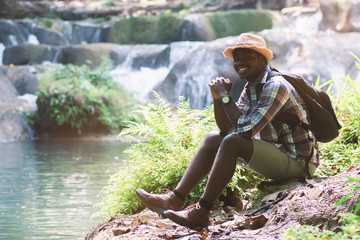 Wall Mural - African Man Traveler with backpack smiling and relaxing