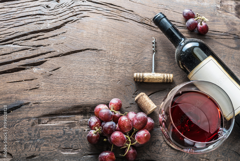 Wine glass, wine bottle and grapes on wooden background. Wine tasting. - obrazy, fototapety, plakaty 