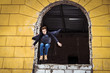 © Mihail - young man jumps out from window escape from abandoned building
