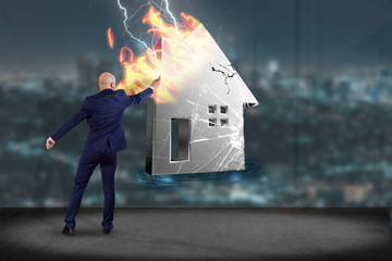 Poster - Businessman in front of a wall with Shinny damaged silver house